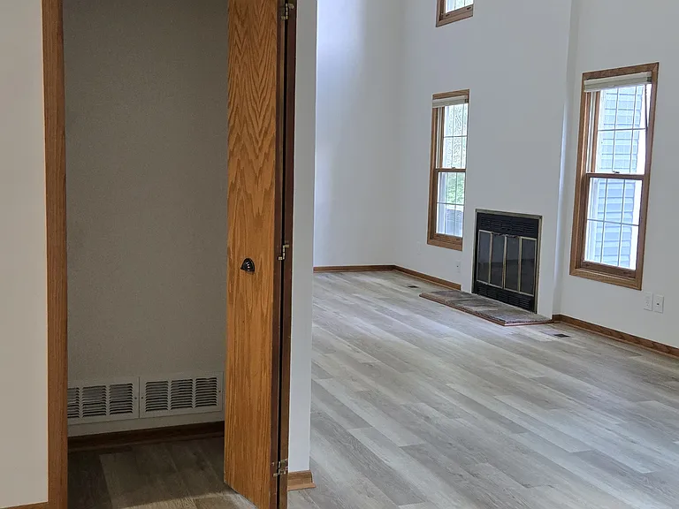 Main floor hall closet with open living space.