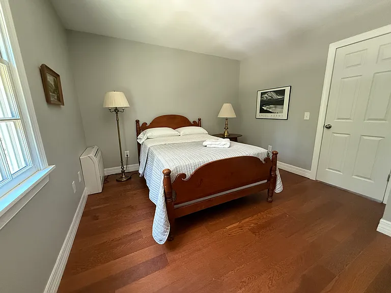 Another guest bedroom with full sized bed. This is part of a "Jack and Jill" arrangement where two guest bedroom share between then one full bath, hence no need to go into hall for the bath