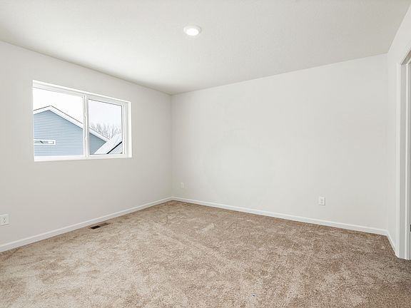 The spare bathroom is spacious and has natural lighting