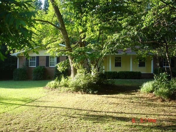 Front view of ranch-style home w/beautiful trees for privacy and protection