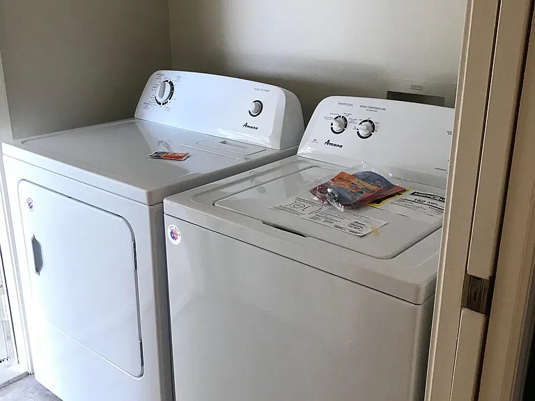 Laundry room with new washer and dryer