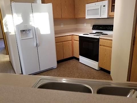 The kitchen includes a new dish washer, new microwave, oven,
