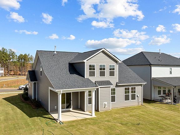 Fairfield design rear elevation with covered rear porch at Lakeside Glen by premier builder DRB Home