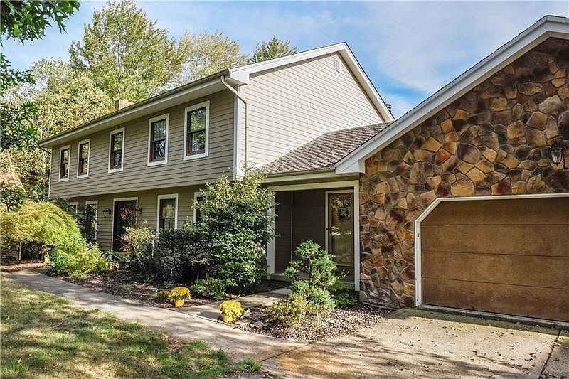 All new low-maintenance Hardi Plank siding with 50 year warranty plus stone front on garage.