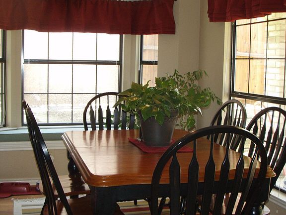 dining area with wood floors and updated lighting