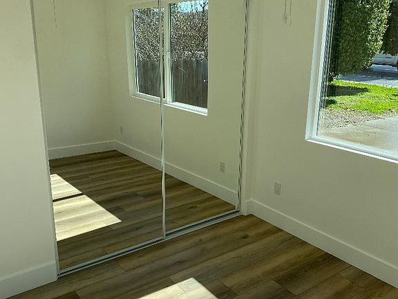 Bedroom with sliding glass mirrors and closet