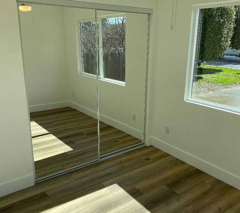 Bedroom with sliding glass mirrors and closet