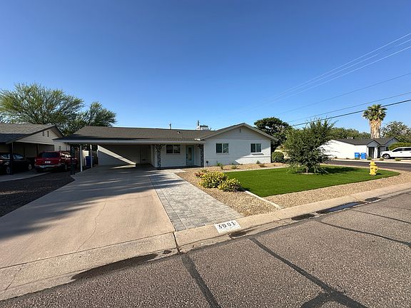 Large Driveway and double covered carport. Synthetic lawn in front with vegetation on a drip system. Great neighborhood with friendly neighbors.