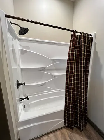 King bedroom #1 full bath with double vanity and shower/tub combo.