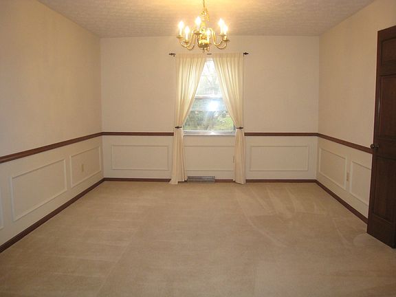 Dining room with new neutral carpet.
