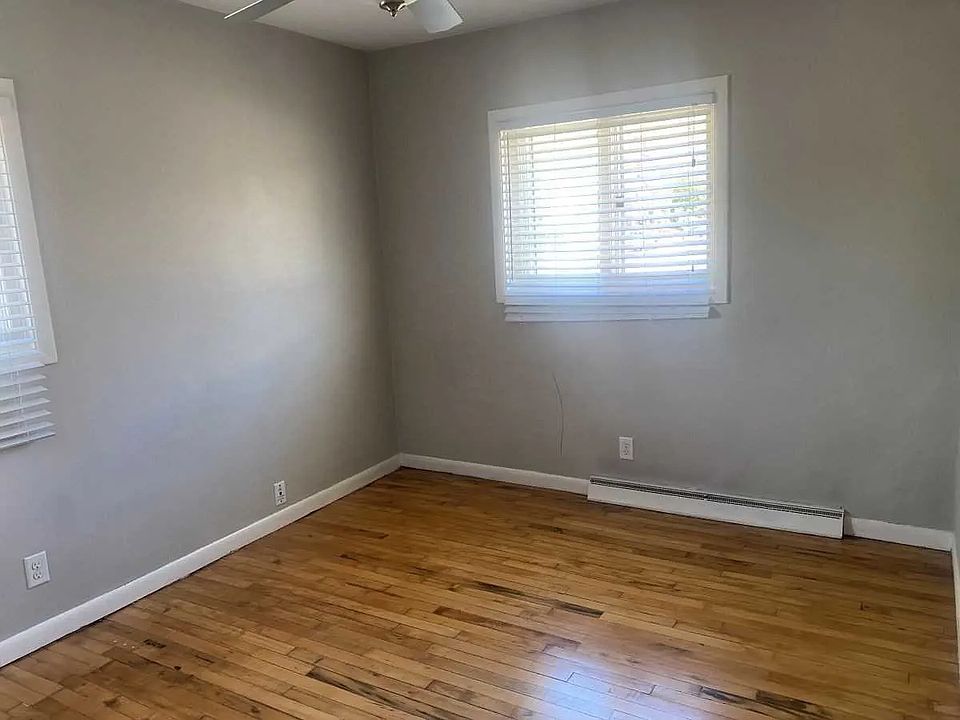 Relax in a bright, comfortable bedroom with hardwood floors and natural light. A simple, peaceful space designed for rest and everyday living.