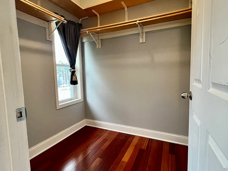 Primary walk in closet, also has a window and is connected to air conditioning. Past tenants have set up work from home office areas and makeup tables in this space.