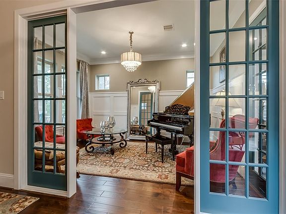 Formal living room with extensive wainscoting and views of the front yard