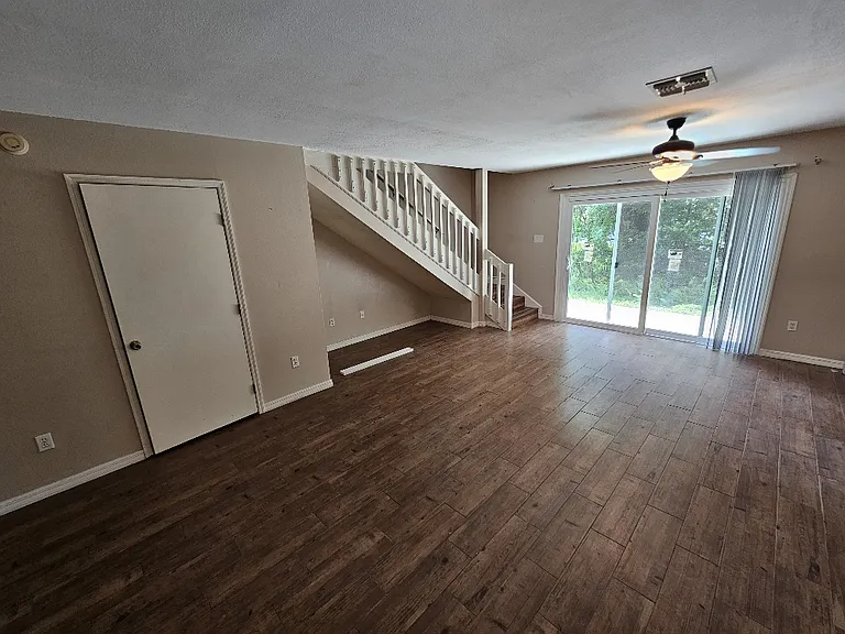 Family room with new sliding doors recently installed with access to green belt behind property