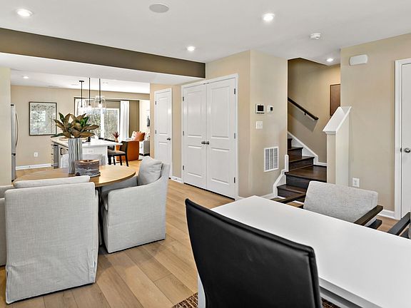Enjoy the dining area in this open-concept floor plan, complete with convenient storage options.