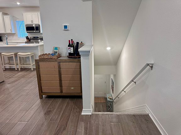 Bar cabinet contains barware for entertaining needs.