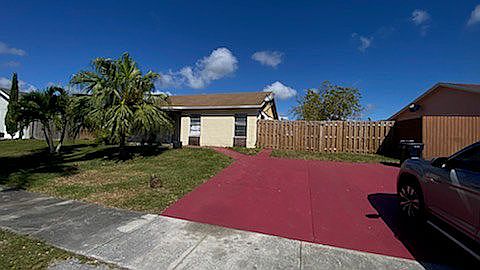 Front yard holds four cars