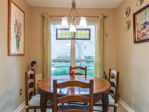 Breakfast Room features views of the beautifully manicured park-like setting of this community offering walking paths and a park bench.
