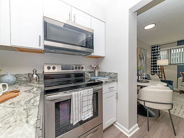 Kitchen with granite counters, stainless appliances, and modern cabinetry