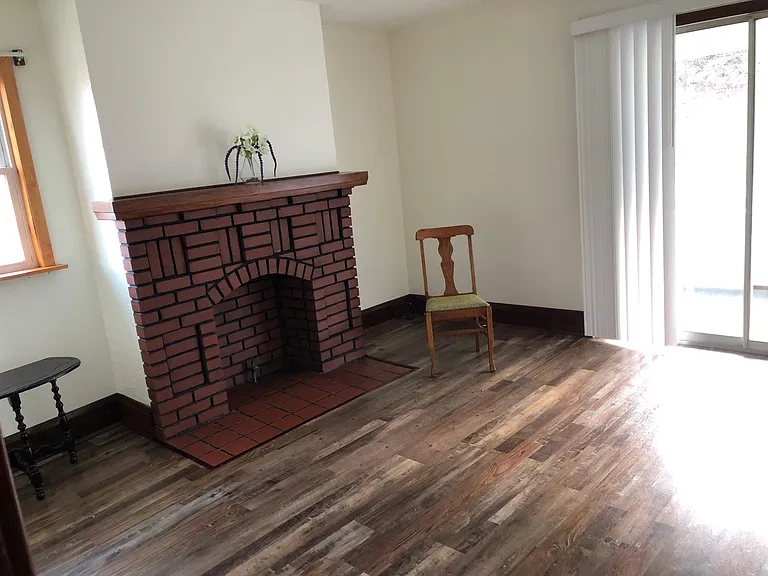 Living room w/vintage non-working fireplace, slider to porch
