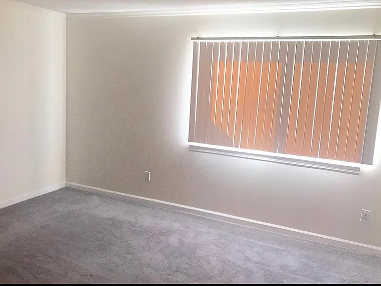 View into the master suite with large windows for ample natural lighting.