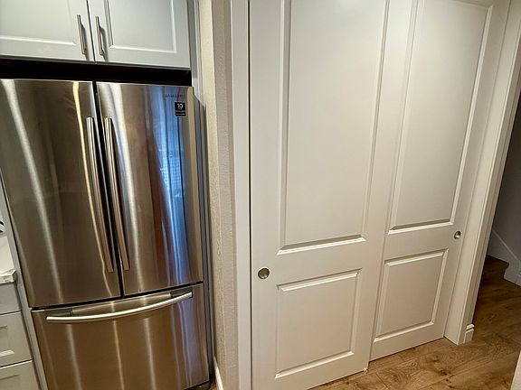 Dedicated laundry closet adjacent to kitchen