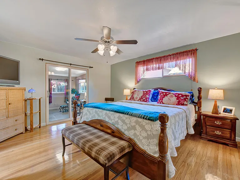 Master bedroom, with sliding door to the family room. Windows above bed is on west side of the house, view of the back yard.