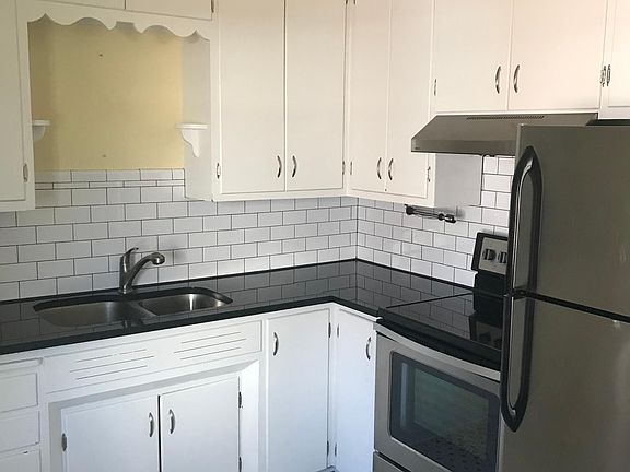 kitchen features granite countertops, stainless steel appliance, classic edge mere floor, pantry