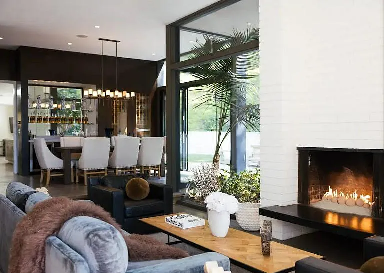 Unwind in the stylish living space, furnished with luxurious seating and bathed in natural light pouring through floor-to-ceiling windows.