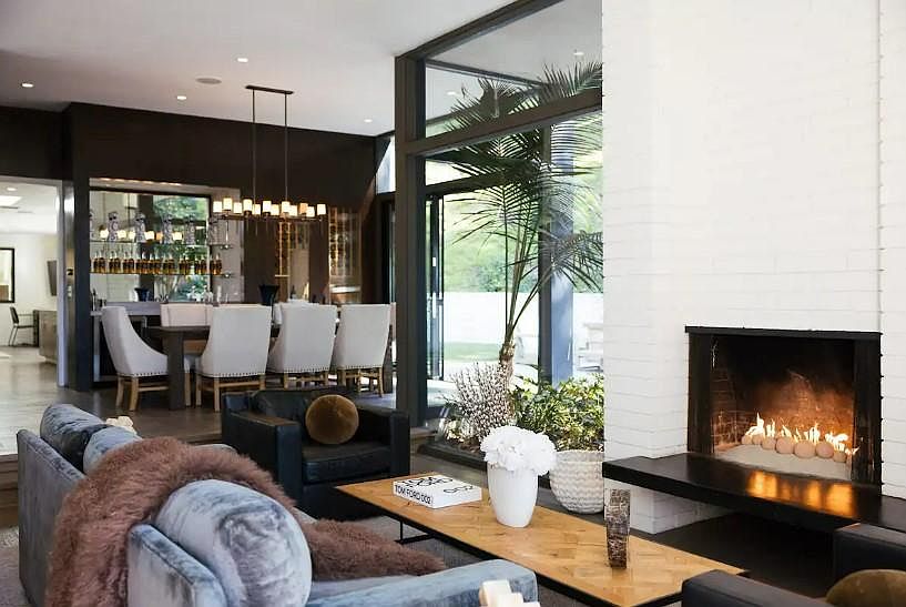 Unwind in the stylish living space, furnished with luxurious seating and bathed in natural light pouring through floor-to-ceiling windows.