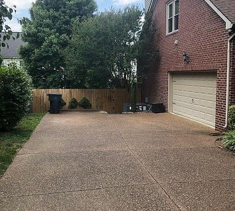 Driveway, garage with bonus room above