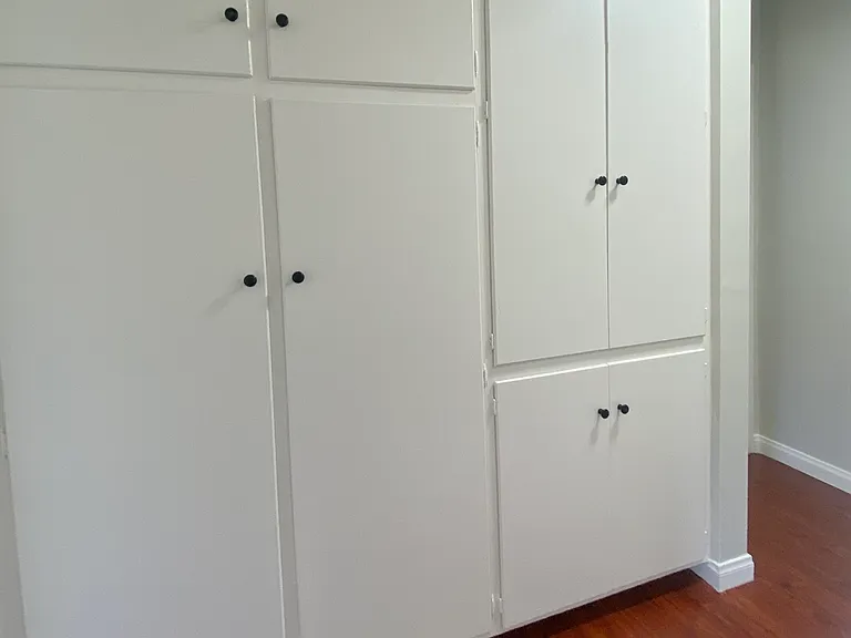 The hallway has a ceiling-to-floor - wall-to-wall built-in storage system