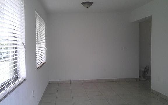 Large Florida Room (other side) opening on the right goes to Dining Area on the left, Kitchen on the right