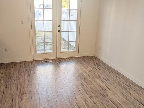 Dining area with french doors that lead to fenced backyard area.