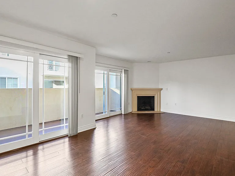 Spacious Living Room with with Vinyl Flooring, Electric Fireplace, and Patio