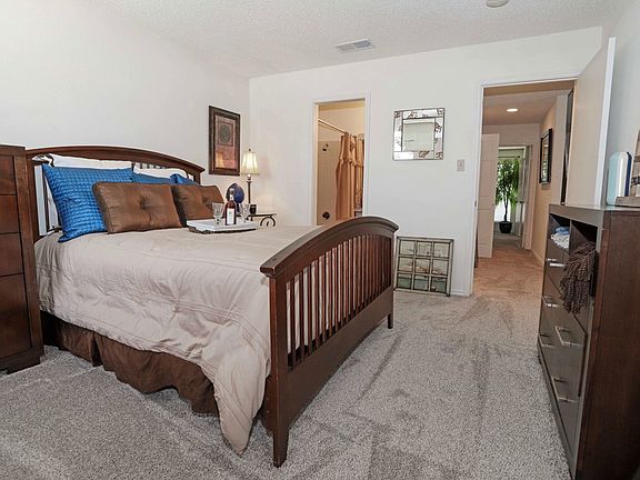 Large bedroom with plush carpeting, natural light, and space to create your perfect retreat