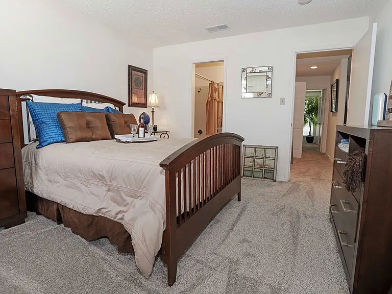 Large bedroom with plush carpeting, natural light, and space to create your perfect retreat