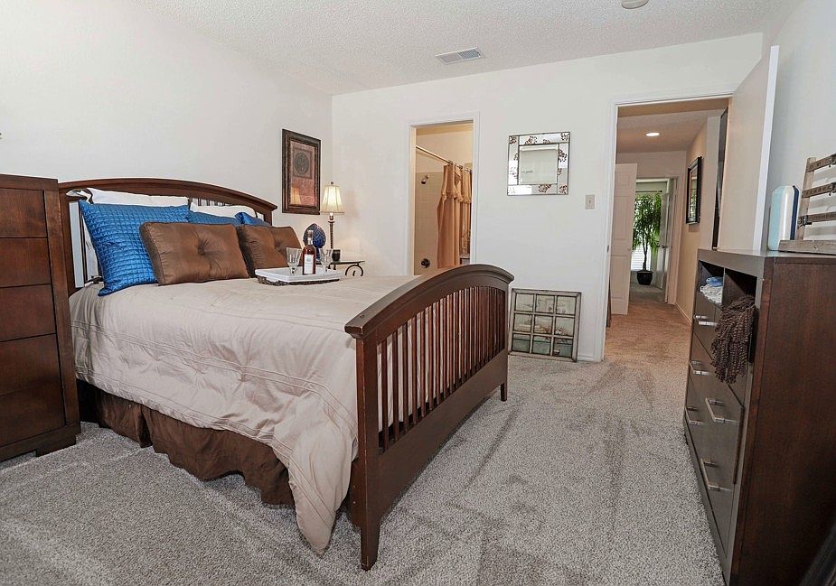 Large bedroom with plush carpeting, natural light, and space to create your perfect retreat