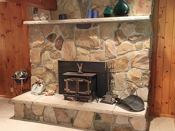 The second fireplace on the main floor is in the living room. This one faced with rich sandstone.
