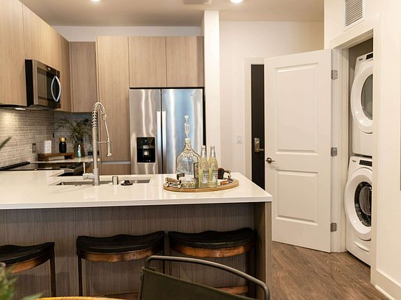 Enjoy the ease of modern living with a sleek kitchen layout and convenient in-unit washer and dryer just steps away.