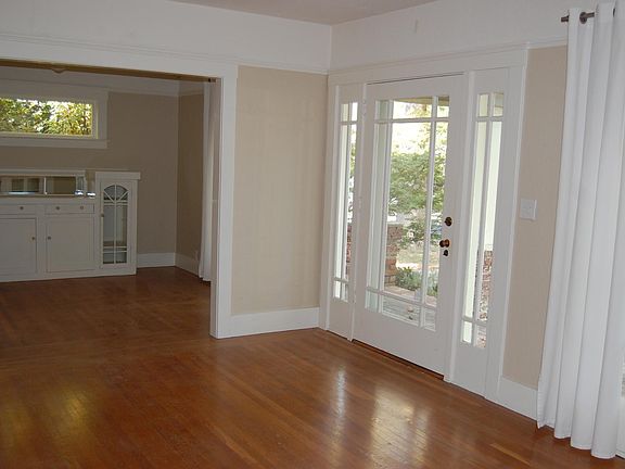 Entry to living room and view of dining room.