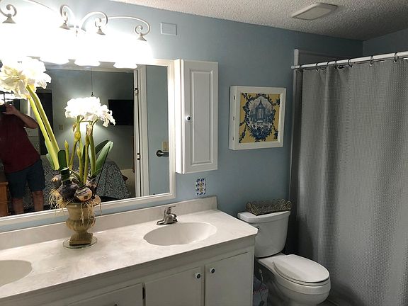 Master Bath with walk-in shower and dual sinks with marble sink