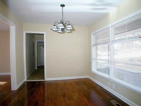 Front dining/sitting room has stylish dropped light fixture