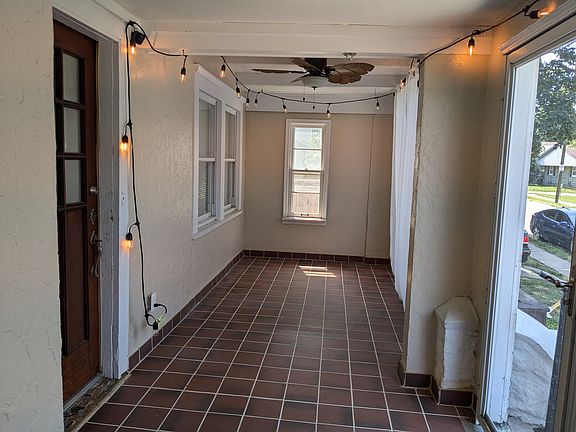 screened in front porch with terra cotta tile