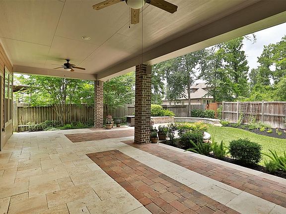Beautiful and ideal for relaxing during any weather. This patio measures 31X14 plus additional 19X16 free-form expansion with stone seating ledges and well landscaped stone planter. This outdoor living space features travertine and paver flooring, ou
