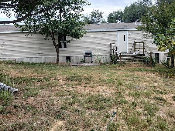 Rear view of the home with a deck.