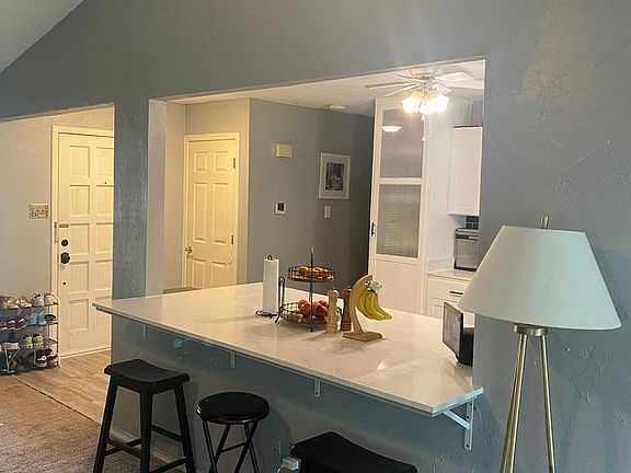 Open kitchen with quartz countertop and complimentary backsplash