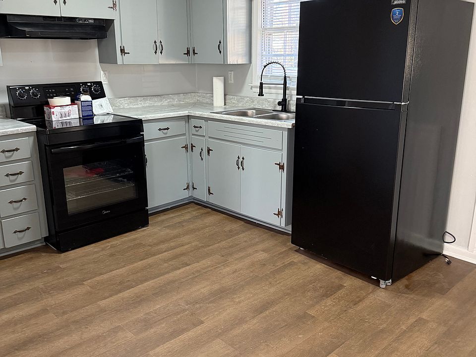 Painted Gray Cabinets with black appliances.