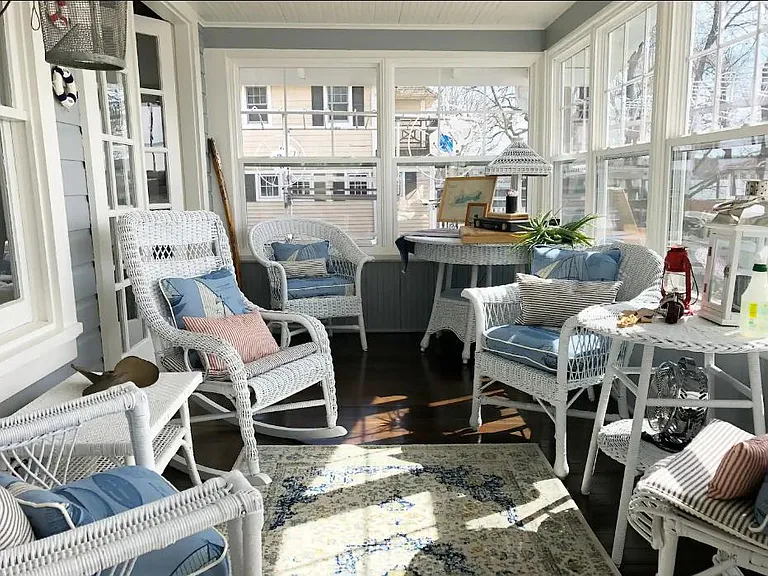 Gorgeous front porch with plenty of seating and a day bed. Enjoy your morning coffee while taking in the beautiful lakefront views.