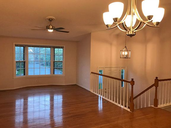 Entry way, foyer, living / dining room with updated fixtures and hardwood floors. Excellent entertaining space with gorgeous views framed by bay windows.